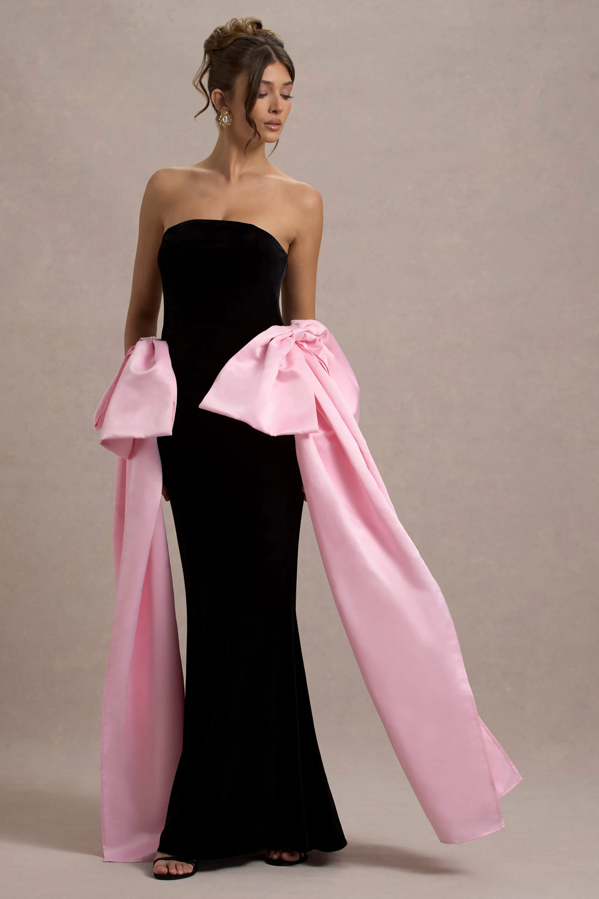 Attention | Robe longue noire sans bretelles avec nuds en satin rose.