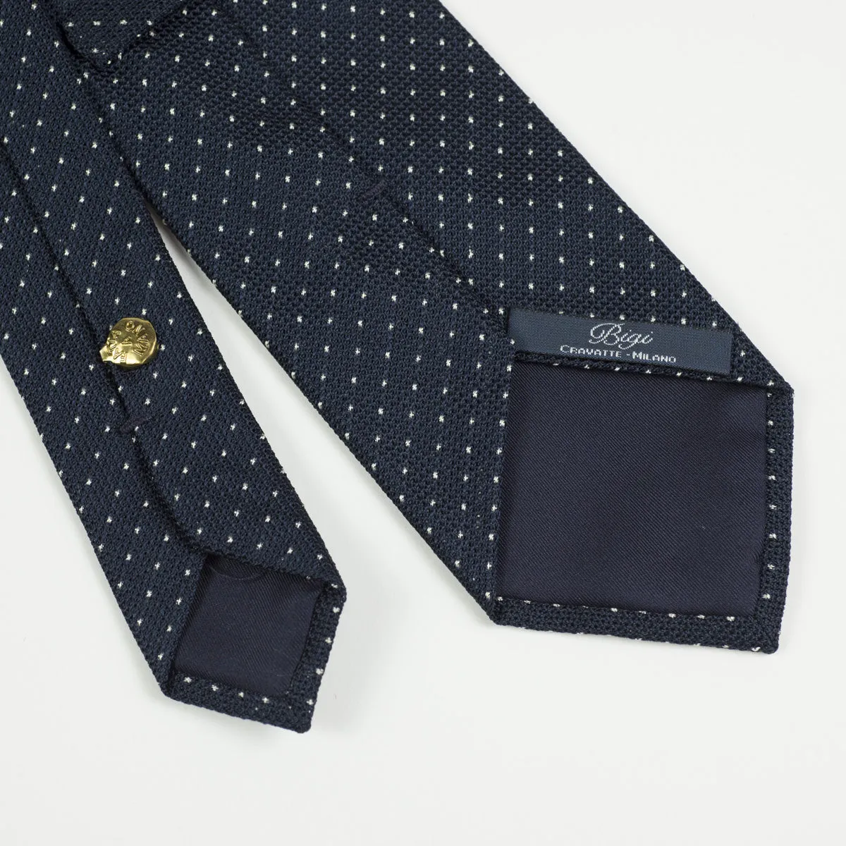 Loosely woven navy silk tie, small white dots