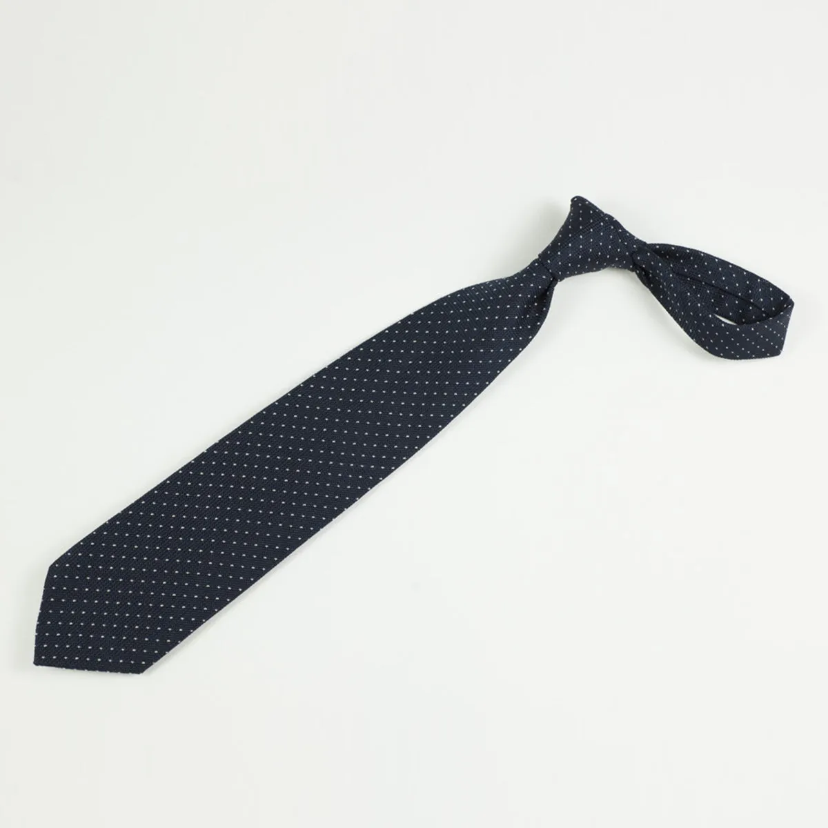 Loosely woven navy silk tie, small white dots