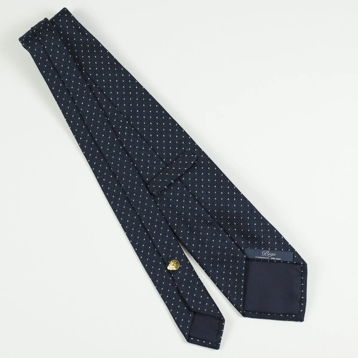 Loosely woven navy silk tie, small white dots