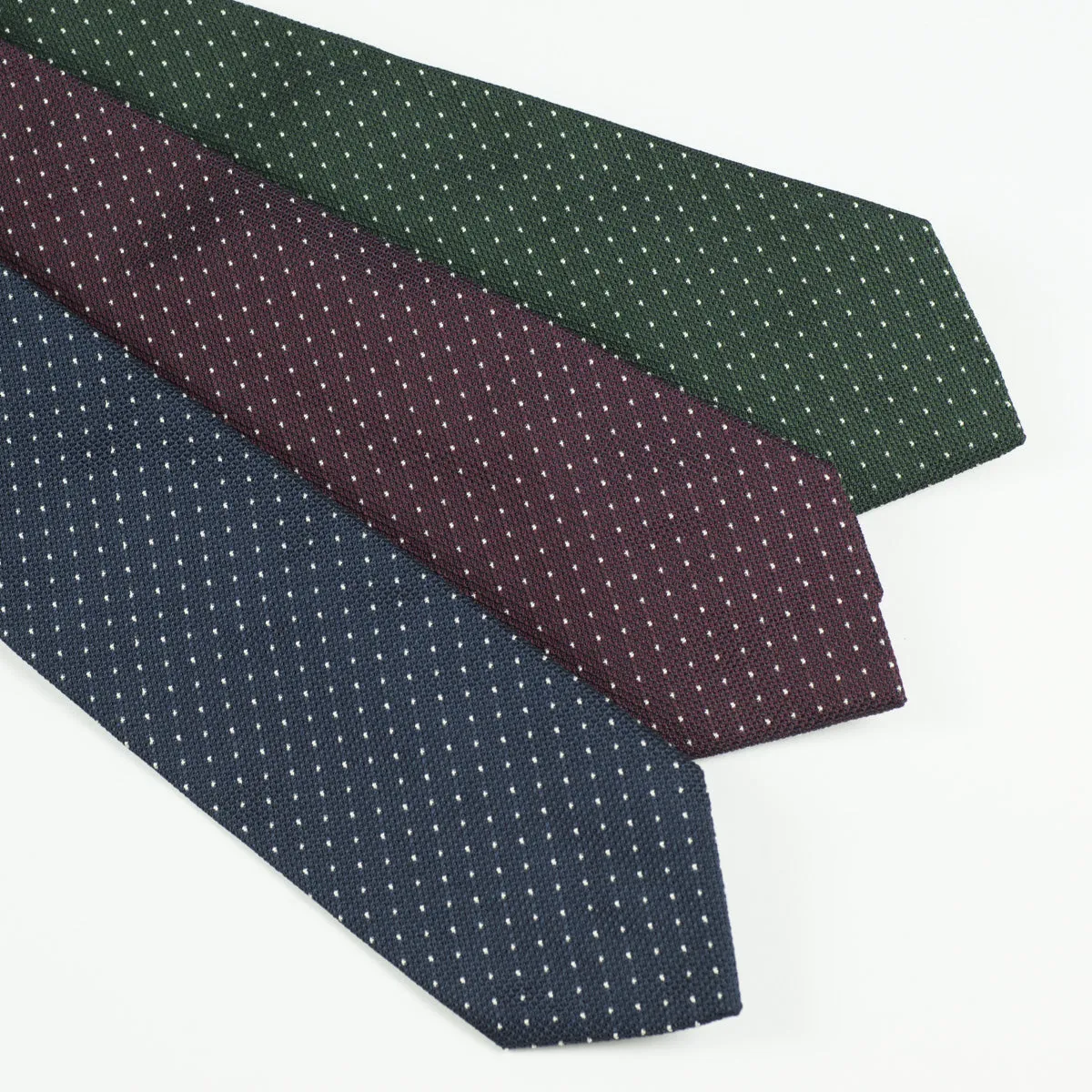 Loosely woven navy silk tie, small white dots