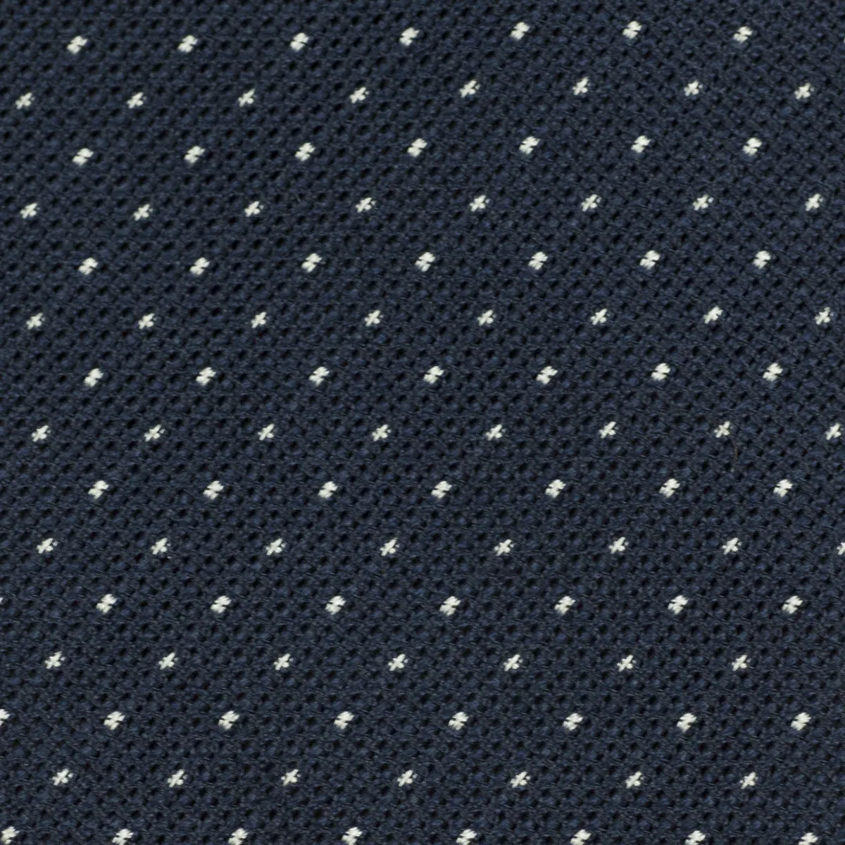 Loosely woven navy silk tie, small white dots